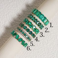 Crafted to perfection, our Lab Grown Emerald Eternity Bands stand out as stunning pieces of elegance. Encased in a fine Gold Band, each ring features a mesmerizing Green Emerald at its center, exuding a sense of sophistication and charm. These Stackable Rings offer versatility, allowing you to mix and match for a personalized touch, perfect for daily wear or special occasions. Whether worn alone or as part of a bridal jewelry set, these bands add a touch of luxury to any ensemble. Elevate your s Luxury Channel Set Emerald Engagement Ring, Luxury Green Eternity Band For Anniversary, Emerald Stackable Ring, Emerald And Diamond Eternity Band, Emerald Anniversary Ring, Emerald Infinity Band, Green Emerald Eternity Band, Emerald Stone Wedding Band, Emerald Green Wedding Band