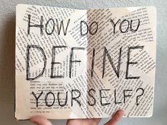 someone holding up an open book with the words how do you define yourself?