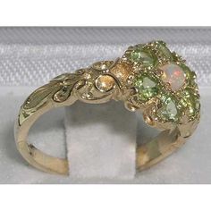 *This ring is made from 375 9K Yellow Gold with Genuine Natural Opal & Peridots.Seven pretty Gemstones all equally sized 3 mm (0.12") round, all hand set in this delightful Solid 9K Yellow Gold Antique style Daisy setting, full of character and charm.  The One central Fiery White Opal surrounded by six Colorful Natural Peridots. *Height 4mm, Width 10mm, Length 10mmPLEASE MAKE SURE YOU STATE THE FINGER SIZE YOU REQUIRE WITH YOUR PAYMENT AND PROVIDE YOUR TELEPHONE NUMBER FOR DELIVERY COURIER.The r Yellow Gold Promise Rings, Bridgerton Engagement Ring, White Gold Peridot Ring, Promise Rings Gold, Colorful Engagement Rings, Gem Stone Rings, Pretty Gemstones, Peridot Ring Gold, Peridot Engagement Rings