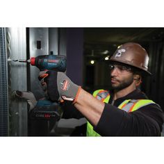 a man in safety gear holding a drill