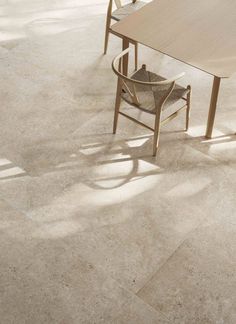 a dining room table and chairs in front of a white tile floor with light coming through the window