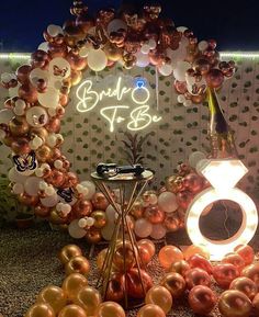 an assortment of balloons and lights in front of a sign