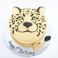 a birthday cake with a leopard face on it