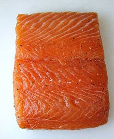 a piece of salmon sitting on top of a white counter