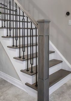 a staircase with metal handrails and wooden steps in a home's entryway