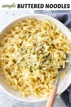 a white bowl filled with pasta and parmesan cheese