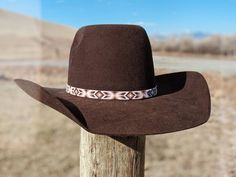 "Beaded hatband that was handmade in Montana using high quality glass seed beads. Contains dark brown, copper, gold, light pink, and white beads. They combine to make a beautiful and delicate rose gold effect. It is 1/2\" wide and 22.5\" long. (Should fit most cowboy hats sizes 7 and larger.) Finished with a leather and suede tie." Southwestern Brown Hat Band, Southwestern Style Brown Hat Band, Beaded Brown Hat Band For Festival, Beaded Brown Hat Bands For Festival, Festival Brown Beaded Hat Bands, Traditional Brown Beaded Hat Bands, Western Brown Beaded Hat, Traditional Brown Beaded Hat, Western Style Brown Beaded Hat