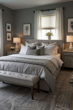 a bedroom with gray walls and white bedding in the center, two lamps on either side