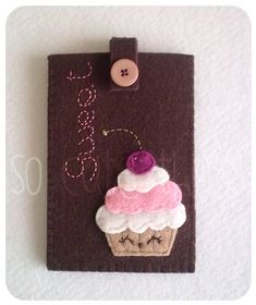 a piece of felt with a cupcake on it and a button attached to it