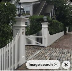 a white picket fence in front of a house