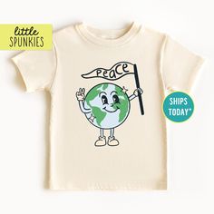 Kids Earth Day Shirt, Retro Earth with Peace Flag T-Shirt, Cute Boho Graphic Tee (NATURAL SHIRT) PRODUCTION TIME Little Spunkies from the designer/owner of Spunky Pineapple Co https://www.etsy.com/shop/SpunkyPineappleCo   All baby and toddler clothes are 100% designed and printed with water based ink. All orders placed before 12:00 pm EST are shipped out same day (Monday - Friday). Orders received after noon are shipped out the next business day. ONESIES® BRAND Made from 100% Cotton. We print on Onesies® Brand. T-SHIRT Made from 100% Cotton. These run true to size. If you are in between sizes we suggest sizing up. CARE Machine wash in cold water, inside out, and tumble dry.   SHIPPING All orders are shipped out via USPS First Class Mail (3-4 days).   Shipping upgrades are available at chec Cute Organic Cotton Crew Neck T-shirt, Pre-shrunk Organic Cotton Short Sleeve Shirt, Cute Organic Cotton T-shirt For Everyday, Cute Everyday T-shirt With Slogan, Playful White T-shirt For Everyday, Casual Graphic Print Shirt For Earth Day, Letter Print Crew Neck Top For Earth Day, Casual Shirt With Graphic Print For Earth Day, Casual Tops With Earth Day Screen Print