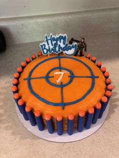 a birthday cake with an orange and blue frosting