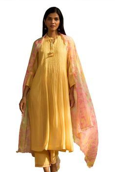 Yellow kurta with intricate smocking details, floral printed tie-up on sleeves and frill edged neckline. Comes with floral printed dupatta and embroidered hem pant. - Aza Fashions Yellow Kurta, Embroidered Hem, Kurta Set For Women, Printed Dupatta, How To Hem Pants, Kurta Set, Pants Pattern, Set For Women, Floral Printed