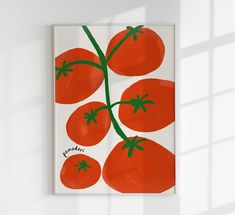 a white wall with a painting of tomatoes on it