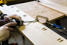 a person using a drill to cut wood