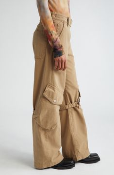 The label's knack for juxtaposing exquisite tailoring with eclectic details shines in these canvas pants featuring off-kilter cargo pockets with belted accents. 31 1/2" inseam; 21" leg opening; 11" front rise; 14 1/2" back rise (size 34EU) Exposed zip fly with snap-tab closure Front slant pockets; back patch pocket; cargo flap-patch pockets Adjustable D-ring belts at knees 100% cotton Machine wash, line dry Imported Designer Clothing Beige Utility Parachute Pants For Fall, Fall Utility Beige Parachute Pants, Beige Straight Leg Parachute Pants With Belt Loops, Khaki Straight Leg Cargo Jeans With Belt Loops, Beige Cargo Style Parachute Pants For Fall, Spring Cargo Jeans With Belt Loops, High Waist Utility Pants With Belt Loops, Fitted Cargo Jeans With Belt Loops For Work, Spring Wide Leg Belted Cargo Pants