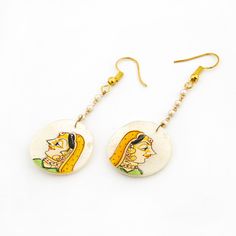 Introducing our exquisite collection of Hand Painted Mother of Pearl Earrings, a true reflection of Indian tradition and craftsmanship. These earrings feature real hand-painted artwork on mother of pearl, showcasing the rich cultural heritage and intricate work of its origin. The delicate hand-painted lady depicted on the mother of pearl exudes the essence of Indian culture and craftsmanship, adding a touch of elegance and charm to the earrings. Each piece is meticulously crafted with attention White Kundan Jewelry Sets, Festive Navratri Jewelry With Matching Earrings, Celebration Jewelry With Matching Earrings For Navratri, Festive Matching Earrings For Navratri, Navratri Celebration Jewelry With Matching Earrings, Elegant White Jewelry For Navratri, Elegant White Jewelry With Artistic Design, Temple Jewelry Style Bridal Earrings As A Gift, Traditional Dangle Jewelry With Artistic Design