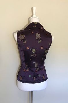 "vintage embroidered silk vest V-neck button down Boutique handmade Tailored fitted Lined in pristine condition size: S measures shoulder to shoulder: 13\" across the chest, arm pit to arm pit: 17\" Waist: 29\" length: 24\" Color: deep eggplant purple, gold, pink, blues, black Comes from smoke/pet free home condition: excellent vintage" Fitted Vintage V-neck Vest, Fitted Floral Embroidered Vest For Fall, Elegant Embroidered Sleeveless Vest, Silk Fitted Vest For Formal Occasions, Formal Fitted Silk Vest, Formal Silk Fitted Vest, Vintage Embroidered Fitted Vest, Vintage Fitted Embroidered Vest, Fitted Vintage Vest With Embroidery