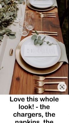 the table is set with white plates and gold cutlers, greenery on each plate