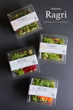 three plastic containers filled with different types of salads on top of a black surface