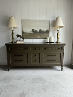 two lamps are sitting on top of a dresser