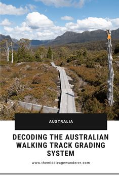 a wooden walkway with mountains in the background and text that reads decoding the australian walking track gradling system