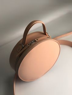 Round crossbody bag of delicately peach color is ready to help you to conquer hearts.  It is for those who want to be in the spotlight!  Who is not afraid to stand out among the crowd and lead! A circle bag leather that with its geometric shape and natural color will dilute any image and make it brighter and more stylish. A leather shoulder bag is the perfect complement to the image of a bridesmaid, it beautifully complements cocktail dresses, looks. Personalized bag will make a wonderful and or Circle Bags, Round Crossbody Bag, Best Gift For Wife, Circle Bag, Bridesmaid Bags, Round Bag, Round Leather, Bridesmaids Personalized, Personalized Gifts For Her