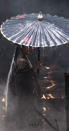 a woman holding an umbrella while standing in the rain with it's lights on