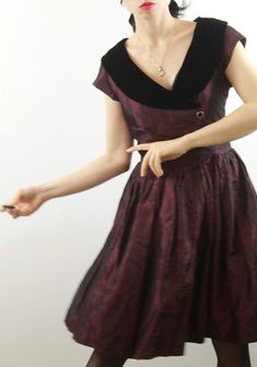 Beautiful vintage burgundi taffetà dress with tulle skirt. Black velvet collar and ribbons for a adorable back bow. Size 6-8 uk. Perfect conditions. All items are vintage and used. However they are all in good to excellent condition. Any defect is specified. Sometimes, small signs of use are to be considered normal. No exchanges and returns, but ask me everything you need! Formal Purple Velvet Dress, Vintage Fitted Velvet Dress, Fitted Vintage Velvet Dress, Vintage Burgundy Dress For Evening, Vintage Burgundy Evening Dress, Burgundy Vintage Evening Dress, Vintage Velvet Party Dress, Retro Purple Formal Dress, Velvet Vintage Dress For Vintage Events