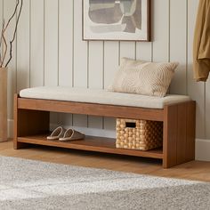 a wooden bench sitting next to a white rug