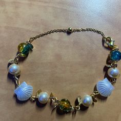 Handmade Gold Seashell Bracelet Mermaidcore Bracelet, Elegant Metal Bracelets For Beach, Elegant Handmade Bracelets For Vacation, Elegant Adjustable Charm Bracelet For Beach, Vacation Bracelet With Lobster Clasp, Blue Metal Bracelets For Beach, Handmade Ocean-inspired Gold Bracelets, Ocean-inspired Beaded Gold Bracelets, Ocean-inspired Gold Beaded Bracelets