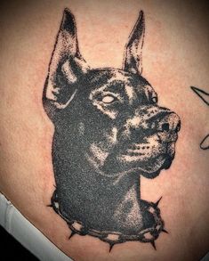 a black and grey dog tattoo on the back of a woman's stomach