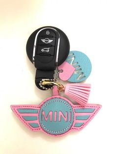 a car keychain with the word mini written on it and various accessories attached to it