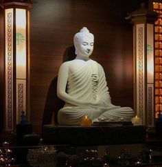 a buddha statue sitting in the middle of a room