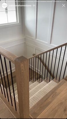 a wooden stair case with metal handrails in a home's entryway