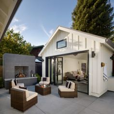 an outdoor living area with patio furniture and bbq