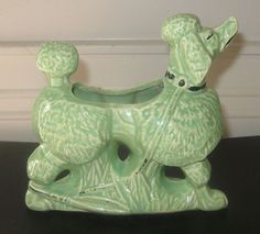 a green ceramic animal on a black table