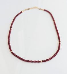 This exquisite handmade Ruby bead necklace boasts the deep, captivating dark pink shade of July's birthstone, with natural Ruby beads carefully selected to create a timeless piece of jewelry. A stunning addition to any bridal outfit or a unique gift for Mom on Mother's Day, this necklace is sure to dazzleA timeless piece, a gift from the heart, a treasure to cherish.T H E ∙ S M A L L ∙ D E T A I L S• Natural Ruby 3mm faceted rondelle beads• Length of necklace: 18 inches + 2 inch 14k Gold filled Wedding Single Strand Rondelle Beaded Necklace, Beaded Rondelle Necklaces For Wedding, Wedding Necklace With Tiny Round Beads, Wedding Necklace With Tiny Beads, Elegant Ruby Beads As Gift, Rondelle Necklace With Faceted Beads For Wedding, Wedding Beaded Necklace With Rondelle Faceted Beads, Wedding Necklace With Rondelle Faceted Beads, Elegant Ruby Beads Gift