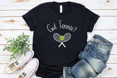 a t - shirt that says got tennis? with a tennis racket and ball on it