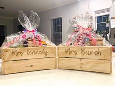 two wooden boxes filled with food on top of a kitchen counter next to each other