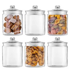 four glass canisters filled with different types of cookies