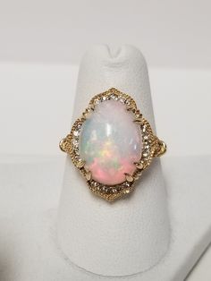 "Thanks for shopping our vintage estate store. We tend to sell well below wholesale and truly hope you enjoy all of our items. Many of the items are one of a kind, so please enjoy scrolling through the pictures and hopefully something will catch your eye. Brown spots are from the camera or reflections. Estate 14k yellow gold natural 4.5ct oval opal .20ct diamond cocktail ring. There are 20 diamonds, and they are nice and bright. Ring size: 6.5 Setting: 5/8\" by 3/4\" Sits up: 3/8\" Gem: 9mm by 11mm Band width: 2mm Weight: 5.17 grams Just stunning ring, one of the prettiest I have seen lately. Marked 14k. As with most estate items there may be some wear on ring. We do not sell new rings, nor do we charge new retail prices." Heirloom Style Oval Diamond Ring With 17 Jewels, Heirloom Oval Diamond Ring With 17 Jewels, Victorian Style White Diamond Ring With Oval Shape, Victorian Style Oval White Diamond Ring, Victorian White Oval Diamond Ring, Victorian Style White Oval Diamond Ring, Vintage Opal Ring For Anniversary, Vintage 14k Stamped Oval Diamond Ring, Vintage Opal Anniversary Ring