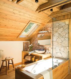 a bathroom with a large tub and wooden walls