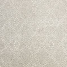 a white rug with diamond shapes on it