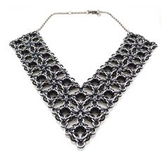 "Turn heads with this dramatic and lightweight necklace. One side is predominately silver; the other side features more black.  With the optional extender, you can wear this piece as a high collar or as a low V necklace.  Nearly 800 aluminum links were joined to create this necklace, which weighs in at a light 2 oz to keep your neck comfortable all evening long.  Each necklace is made to order and may take up to 2 weeks to ship. Choose your necklace length - the length shown is measured across t Elegant Black Chainmail Jewelry, Black Metal Chainmail Necklace, Gothic Silver Box Chain Necklace, Chainmail Patterns, Black Necklace Statement, V Necklace, Chainmail Jewelry, Bib Necklaces, One Ring