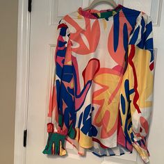 Beautiful Multicolored Top Never Worn Smock Sleeves And Pleated Neck. Length Is 25 In Fast Is 20 Inches Extra Button Enclosed Hundred Percent Polyester Single Button At Top And Back Stretch Multicolor Blouse For Spring, Trendy Multicolor Color Block Blouse, Multicolor Long Sleeve Blouse For Day Out, Casual Multicolor Blouse With Abstract Print, Bold Multicolor Tops For Spring, Red Casual Blouse With Colorful Pattern, Casual Red Blouse With Colorful Pattern, Multicolor Stretch Long Sleeve Blouse, Vibrant Multicolor Blouse With Bold Print