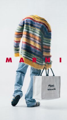 a man holding a shopping bag in front of his back with the word marni on it