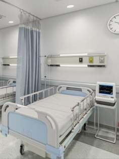 an empty hospital room with three beds and a clock