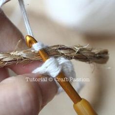 a person is holding a piece of yarn and crocheting it with two needles