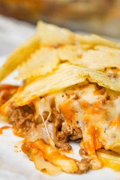 a close up of a plate of food with cheese and other foods on the side